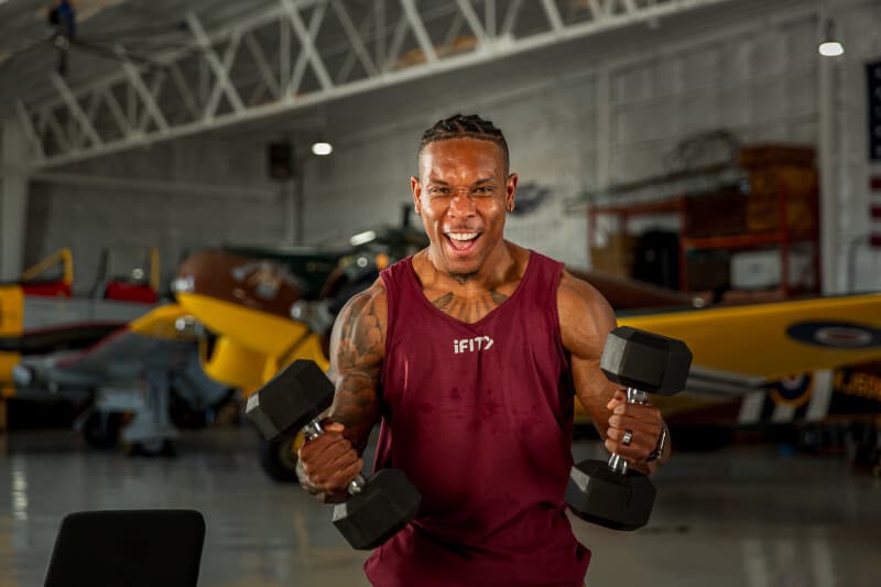 Darryl “BullyJuice” Williams performs a strength workout with dumbbells as part of the iFIT Next program announcement introducing him as the inaugural athlete.
